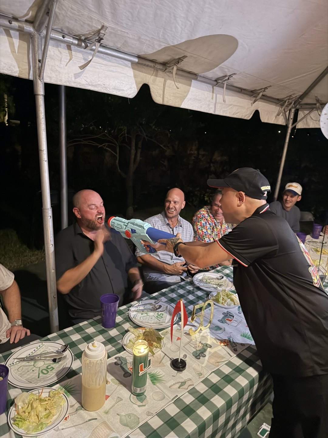 Hibachi C2 chef sharing a playful moment with smiling party guests